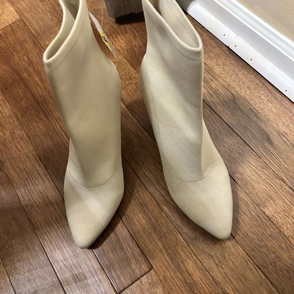 Ladies cream color boots. Stretch material. Never worn tag attached.